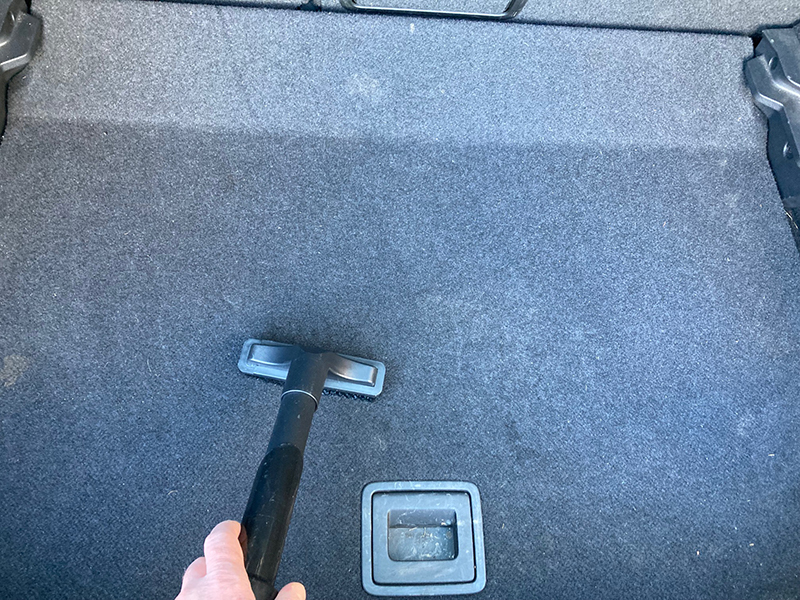 The upholstery brush attachment that comes with the James vacuum being used to clean a car boot.