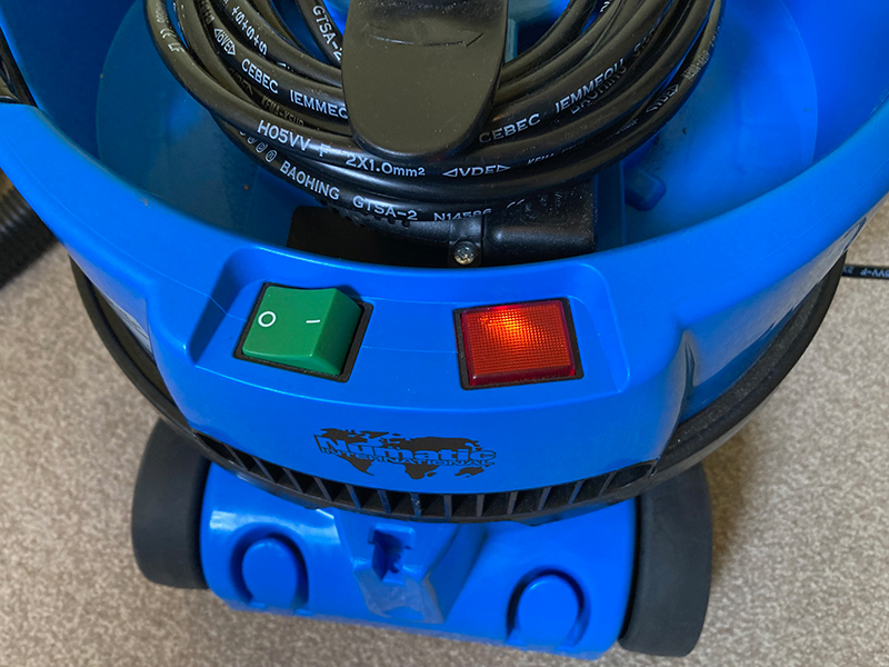 The switch on a James vacuum on and the indication light lit.