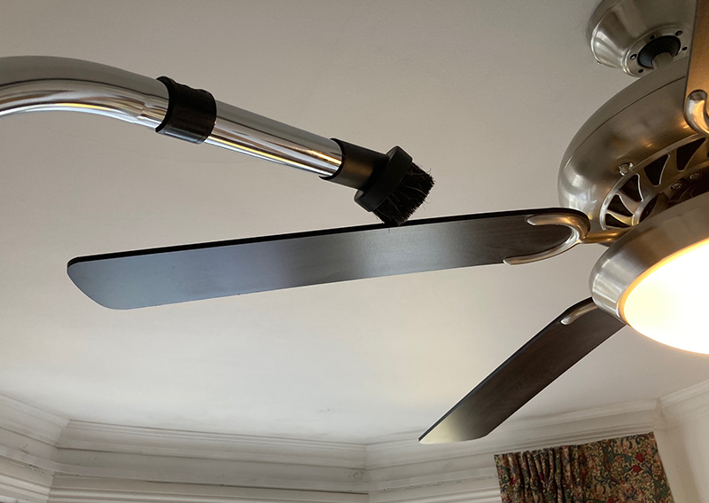 Henry Xtra soft dusting brush being used on a ceiling fan