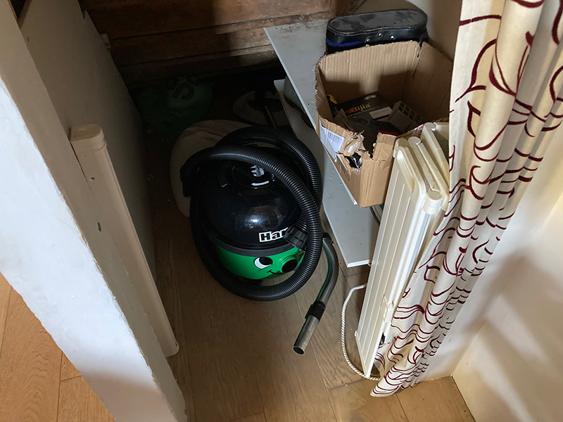 Storing a Harry vacuum cleaner under a staircase