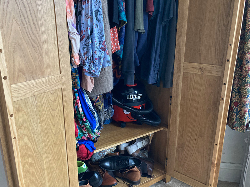 The Henry Cordless being stored inside a wardrobe.