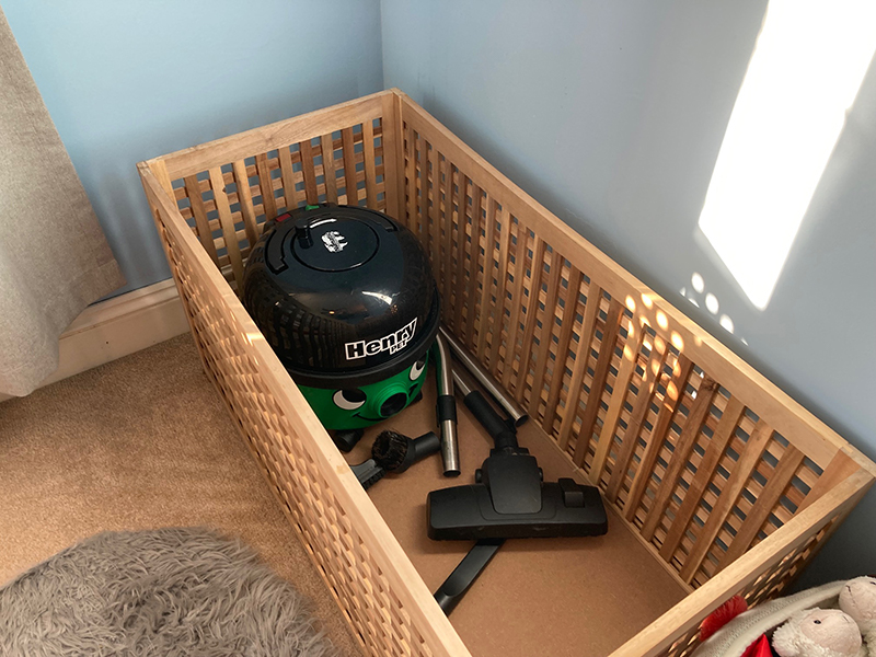 A Henry Pet vacuum cleaner being stored in a chest.