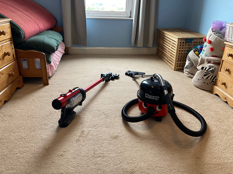 A Henry Quick vacuum cleaner next to a Henry vacuum cleaner